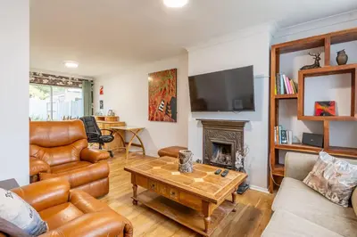 a living room with leather furniture and a fireplace at Pass the Keys 3-Bedroom Home in Chelmsford Sleeps 7 in Chelmsford