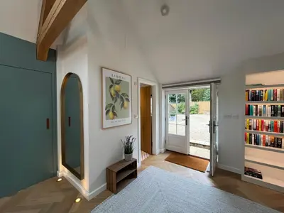 a room with a mirror and a book shelf at Luxury Designer Boutique Annexe - Walk to Award Winning Pub in Sibton