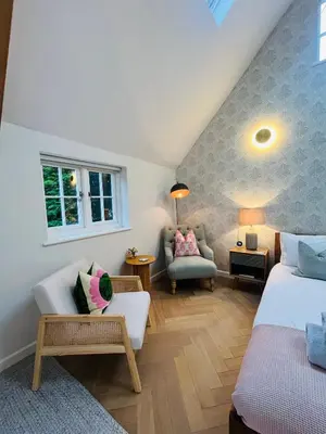 a room with two beds and a couch and a chair at Luxury Designer Boutique Annexe - Walk to Award Winning Pub in Sibton