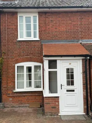 a brick house with a white door and windows at Cosy two bedroom house in eye Suffolk with parking near A140 in Eye