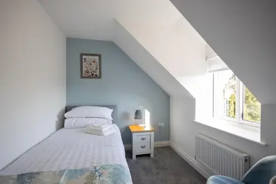 a bedroom with a bed and a window at The Nook - Sizewell - Contractor Accommodation in Aldringham