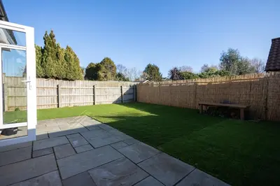 a backyard with a fence and a picnic table at The Nook - Sizewell - Contractor Accommodation in Aldringham