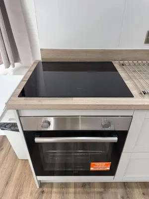 a kitchen counter with a stove top oven at Cinema room apartment 2 in Basildon
