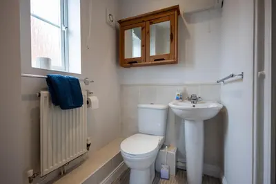 a bathroom with a toilet and a sink at Brook - Sizewell - Contractor Accommodation in Saxmundham