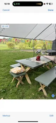 a group of picnic tables with a large tent at Lookout cabin farm stay firepit Hertford in Hertford