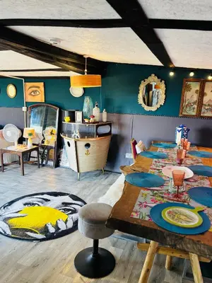 a room with two beds and a table and a sink at Lookout cabin farm stay firepit Hertford in Hertford