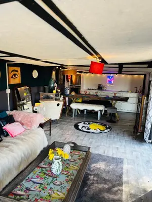 a living room with a couch and a table at Lookout cabin farm stay firepit Hertford in Hertford