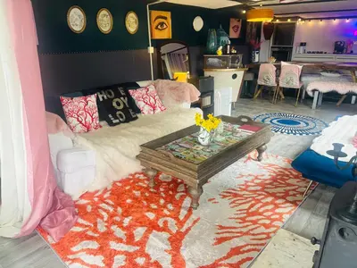 a living room with a couch and a table at Lookout cabin farm stay firepit Hertford in Hertford