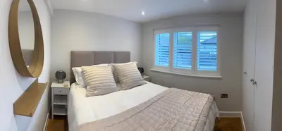 a bedroom with a large bed and a window at Little Dunton Lodges 1 in Little Burstead