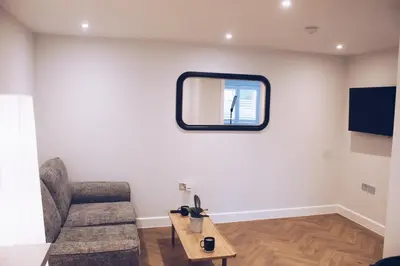 a living room with a couch and a table at Little Dunton Lodges 1 in Little Burstead