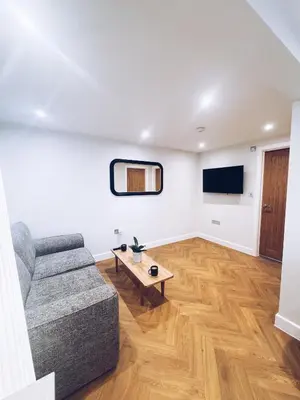 a living room with a couch and a table at Little Dunton Lodges 1 in Little Burstead