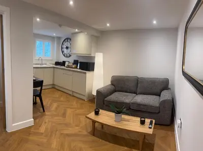 a living room with a couch and a table at Little Dunton Lodges 1 in Little Burstead