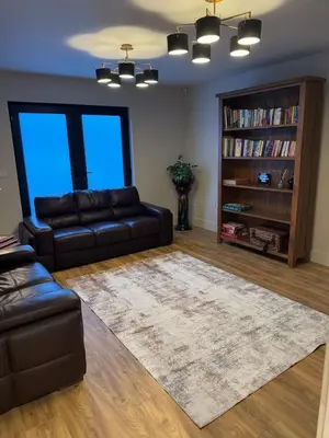 a living room with a couch and a book shelf at Kim's Place in Hingham