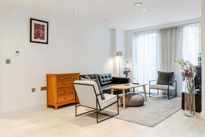 a living room with a couch and a table at Tailored Stays - Central Station Apartments in Cambridge