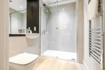 a bathroom with a shower with a toilet and a sink at Tailored Stays - Central Station Apartments in Cambridge