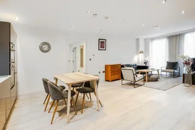 a kitchen and living room with a table and chairs at Tailored Stays - Central Station Apartments in Cambridge