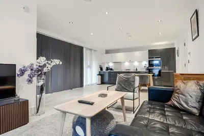 a living room with a couch and a table at Tailored Stays - Central Station Apartments in Cambridge