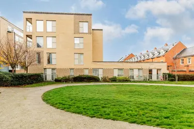 a large grassy yard in front of a building at Tailored Stays - Central Station Apartments in Cambridge