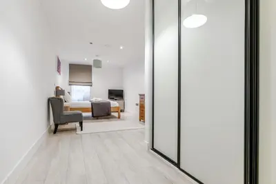 a bedroom with a bed and a sliding glass door at Tailored Stays - Central Station Apartments in Cambridge