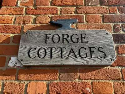 a sign on a brick wall with the words force quarters at Charming 1BR Cottage in Aldringham in Aldringham