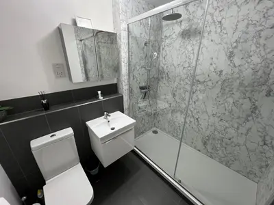 a bathroom with a shower and a toilet and a sink at Charming 1BR Cottage in Aldringham in Aldringham