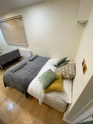 a bedroom with a large bed in a room at Charming Cambridge Studio with Private Garden in Cherry Hinton