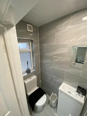 a small bathroom with a toilet and a sink at Charming Cambridge Studio with Private Garden in Cherry Hinton