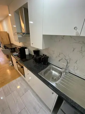 a kitchen with a sink and a counter top at Charming Cambridge Studio with Private Garden in Cherry Hinton