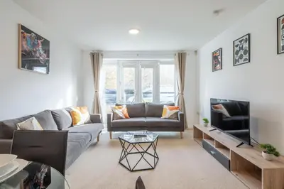 a living room with a couch and a tv at Spacious 2BR I 2BA I Sleeps 4 I Near Science Park in Milton