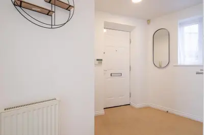 a white hallway with a door and a mirror at Spacious 2BR I 2BA I Sleeps 4 I Near Science Park in Milton