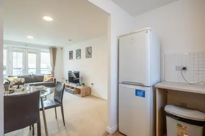 a kitchen and living room with a refrigerator and a table at Spacious 2BR I 2BA I Sleeps 4 I Near Science Park in Milton