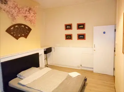 a bedroom with a bed and a wall with pictures at Home stay central in Cambridge