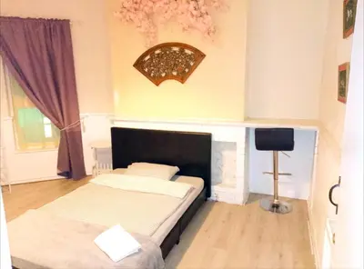a bedroom with two beds and a television in it at Home stay central in Cambridge