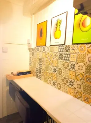 a kitchen with a counter with tiles on the wall at Home stay central in Cambridge