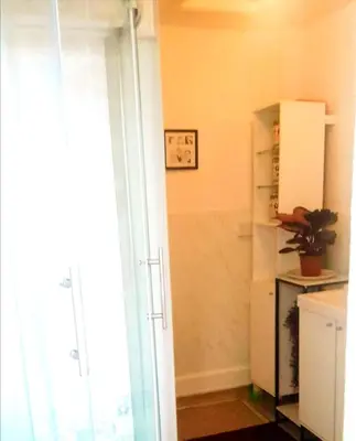 a kitchen with a white refrigerator and a window at Home stay central in Cambridge