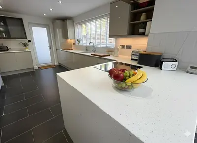 a bowl of fruit on a counter in a kitchen at Easy walk to Addenbrookes - Stylish 1 bedroom Apartment in CBG