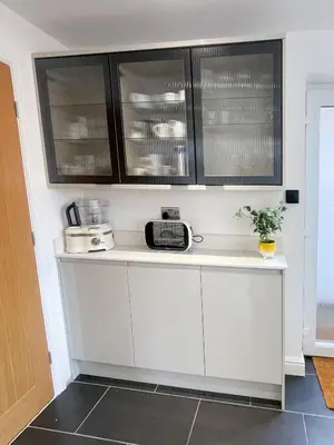 a kitchen with white counters and black cabinets at Easy walk to Addenbrookes - Stylish 1 bedroom Apartment in CBG