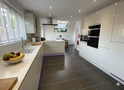 a kitchen with white cabinets and a bowl of fruit on a counter at Easy walk to Addenbrookes - Stylish 1 bedroom Apartment in CBG