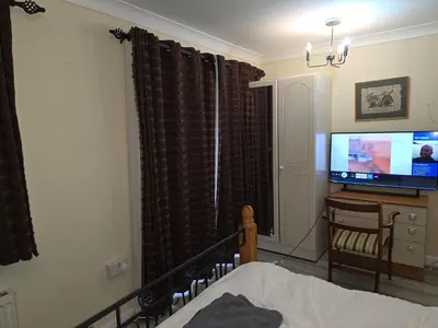 a bedroom with a bed and a tv in a room at Colchester CO1 Hythe Ta in Hythe