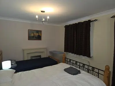 a bedroom with two beds and a fireplace at Colchester CO1 Hythe Ta in Hythe