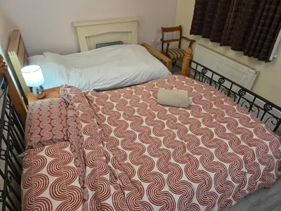 a bedroom with a bed with a comforter on it at Essex Colchester Cosy Room Zi in Hythe