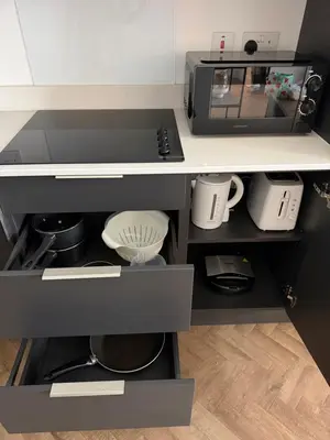 a kitchen with a counter top with a microwave at Cosy one bedroom flat in the heart of Chelmsford in Chelmsford