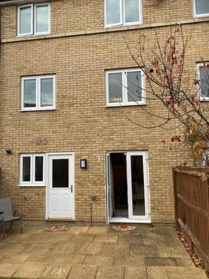 a brick building with a white door and windows at Warm & Cosy 4 Bed Cambridge House w Parking Garden & High Speed WIFI in Milton
