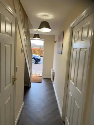 a hallway with a door and a car in a driveway at Warm & Cosy 4 Bed Cambridge House w Parking Garden & High Speed WIFI in Milton