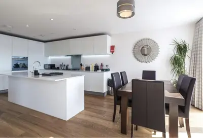 a kitchen and dining room with a table and chairs at The Luxurious Semi-Circle in Cambridge