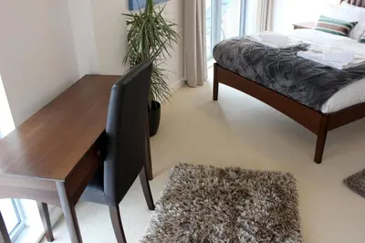 a bedroom with a bed and a desk and a table at The Luxurious Semi-Circle in Cambridge