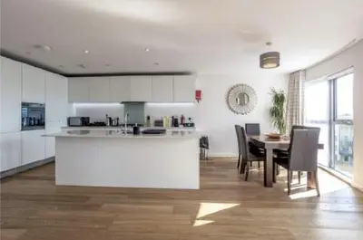 a kitchen and dining room with a table and chairs at The Luxurious Semi-Circle in Cambridge