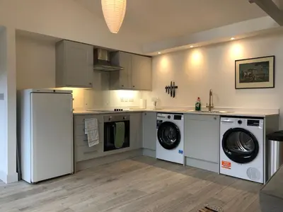 a kitchen with washing machines and a washer and dryer at Perfitt Place in Bungay
