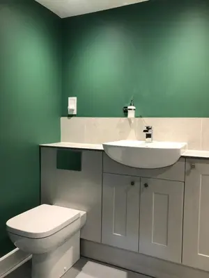 a bathroom with a white sink and a toilet at Perfitt Place in Bungay