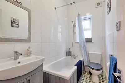 a white bathroom with a sink and a toilet at Comfortable 2-Bedroom Home for 6, Perfect for Families, Contractors & Longer Stays, Clark Property Estates in Southend-on-Sea